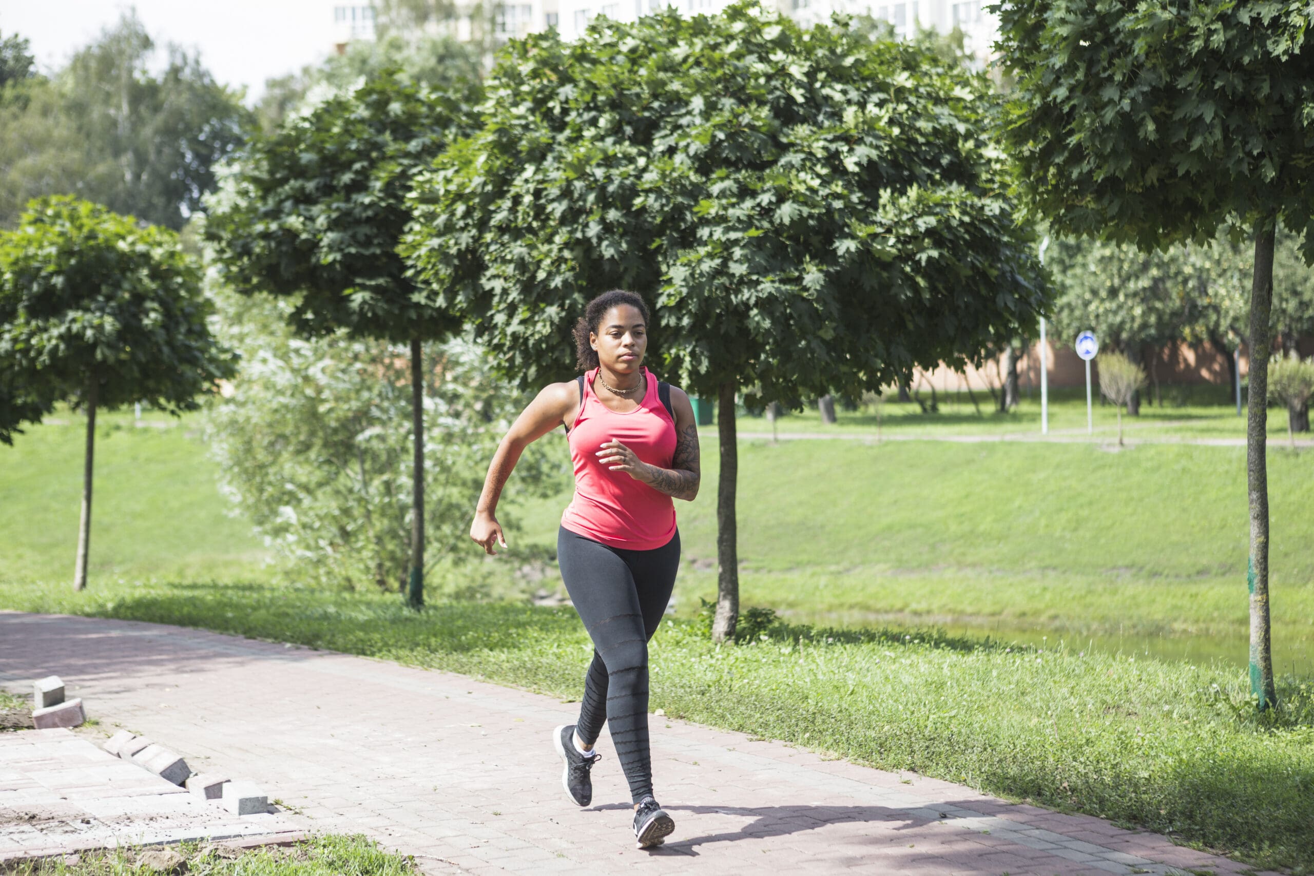 woman walking in park for exercise while on GLP-1 weight loss journey
