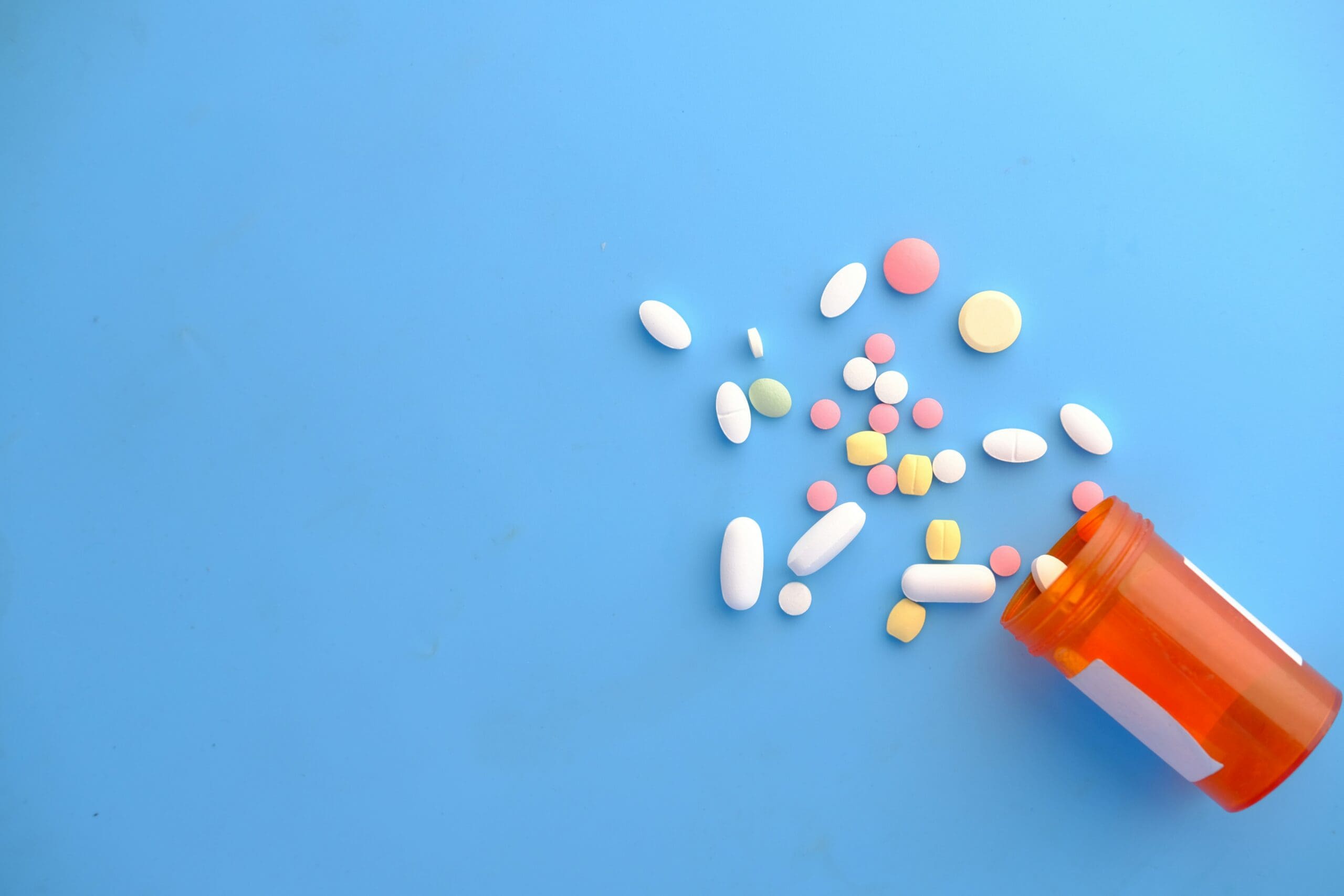 Oral GLP-1 medications including oral Wegovy tablets spilling from prescription bottle